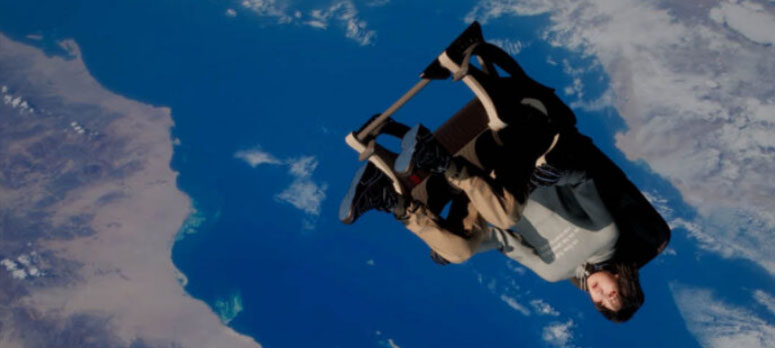 person sitting on chair while falling down onto earth